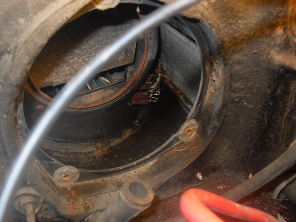 close-up of blower motor housing with wires and rust