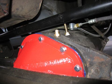 1989 Ford Bronco - A freshly painted differential cover is installed on the rear axle of a vehicle.