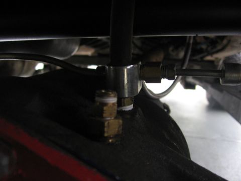 1989 Ford Bronco - Detail of a brake line fitting attached to the rear axle assembly.