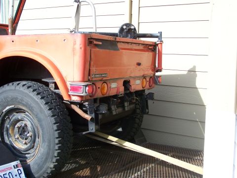 1988 Suzuki Samurai - This orange flatbed truck is shown from the rear, with a visible '4-Wheel Drive' badge.
