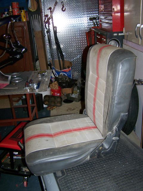 1988 Suzuki Samurai - A single car seat is shown in a cluttered garage environment.
