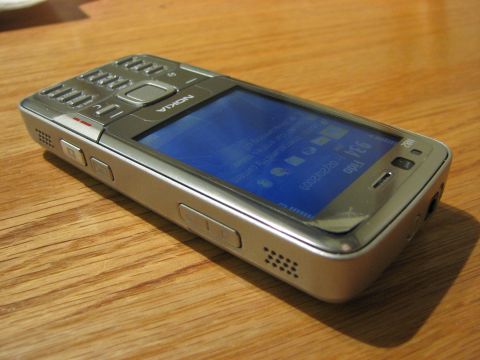 2003 Ford Crown Victoria - Nokia N82 phone with screen displaying icons and date 02/02/2009.