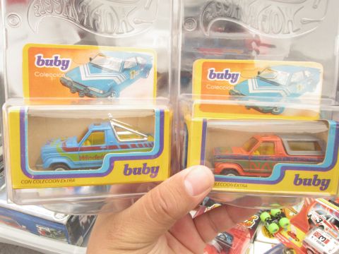 1986 Ford Bronco - Buby toy trucks are displayed in their original packaging, colorful designs.
