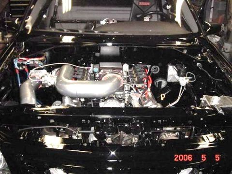 2007 Ford Mustang - The engine bay of a black vehicle, with a date stamp indicating May 5, 2006.