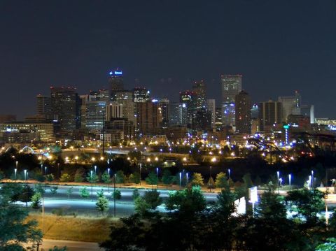 1996 Ford Bronco - A wide view of a city skyline at night, with numerous lights from buildings and street lamps visible.