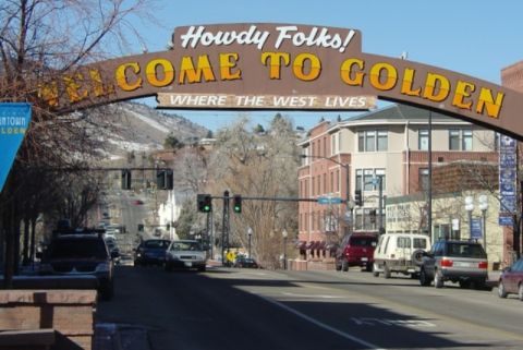 1996 Ford Bronco - A street view of Golden, Colorado, several SUVs and the iconic 'Howdy Folks! Come to Golden' welcome arch.