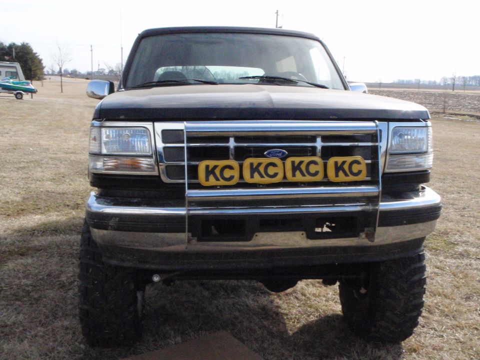 Black 1996 Ford Bronco front view with KC lights