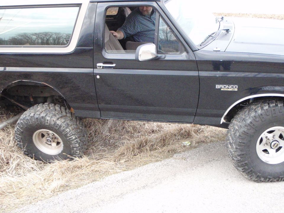 Black 1996 Ford Bronco side view with off-road tires.