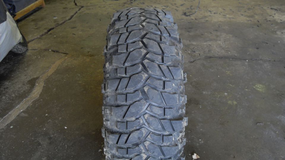 Knobby off-road tire on cracked concrete floor