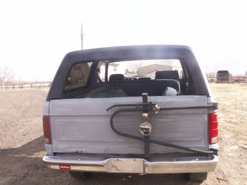 Rear view of a 1986 Ford Bronco with a spare tire carrier mounted on the tailgate
