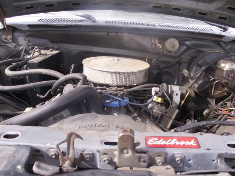 1986 Ford Bronco - Engine bay of a 1986 Ford Bronco, an Edelbrock air cleaner and visible engine components.