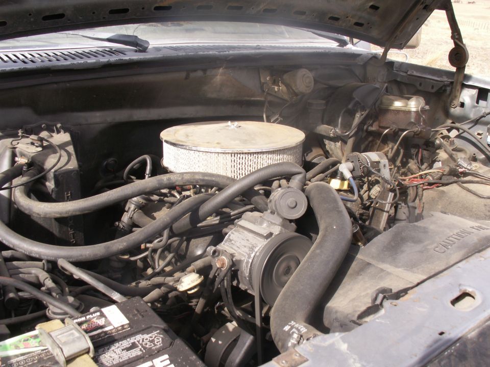 Engine bay of a 1986 Ford Bronco with a V8 engine and air filter