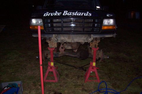 1995 Ford Bronco - This Ford truck is raised on jack stands, showing its front end and underside.