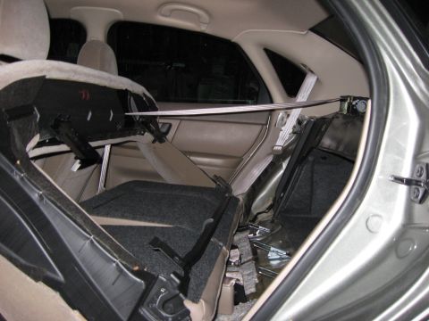 2003 Ford Taurus - Removing the back seat and parcel shelf (13mm bolts).