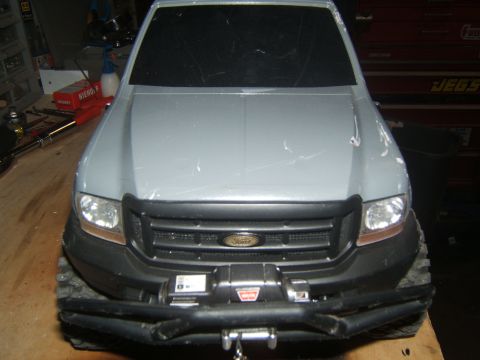 1988 Ford Bronco - This is a close-up of the front of an RC truck, a winch and the Ford emblem.