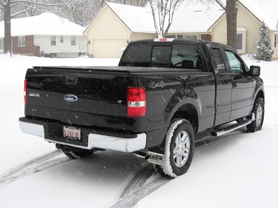 Black Ford F-150 pickup truck in the snow