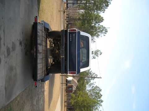 1978 Ford Bronco - A dark blue and white Ford Bronco is loaded onto a trailer, ready for transport.