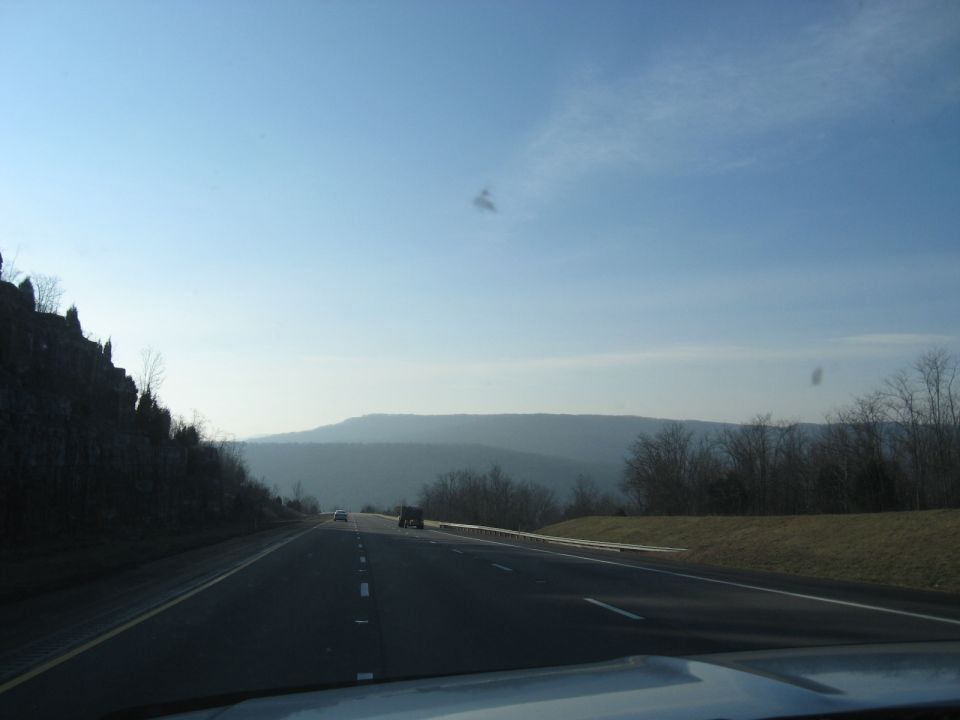 Highway through mountains under a clear blue sky