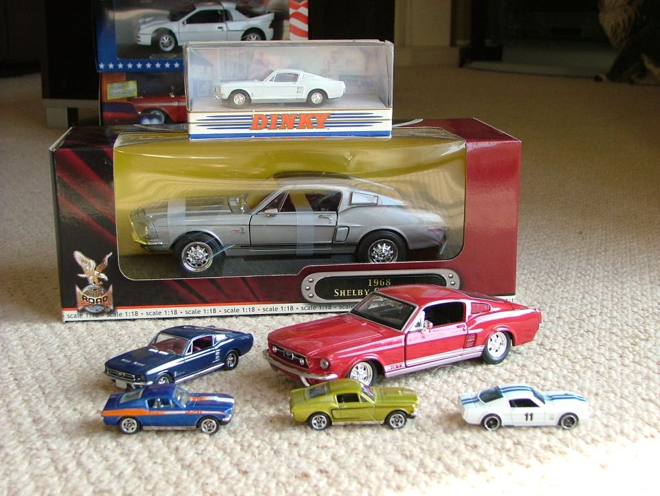 Collection of Ford Mustang scale models, boxed and loose, on carpet