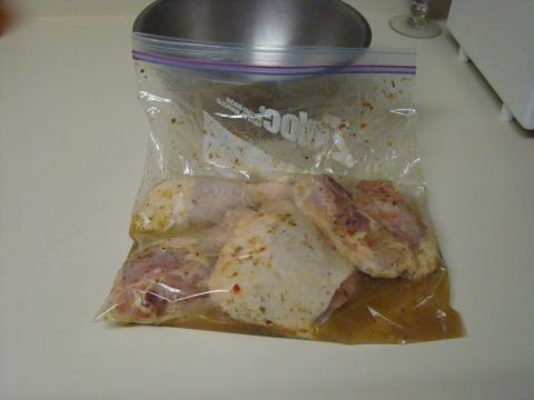 1989 Ford Bronco - Several pieces of raw chicken are marinating in a clear plastic bag with a zipper closure. The bag is filled with a liquid marinade and spi…
