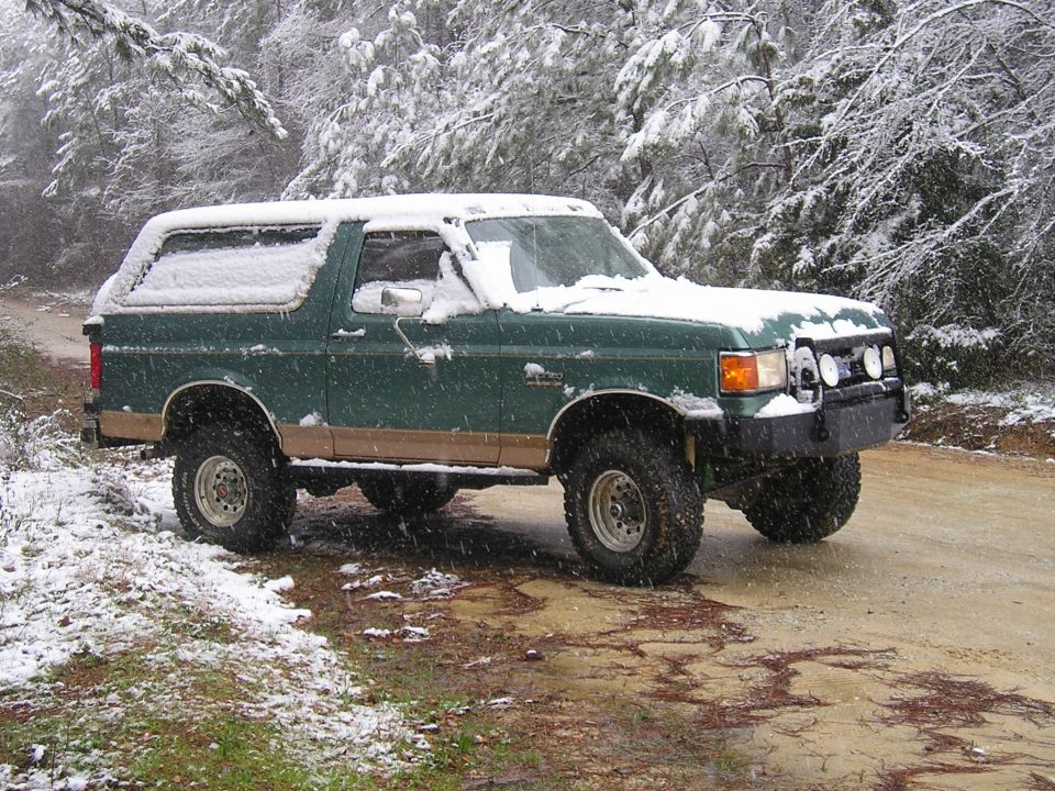 Green Ford Bronco in the snow