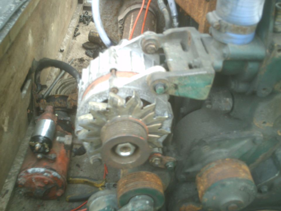 Engine bay with alternator and starter motor
