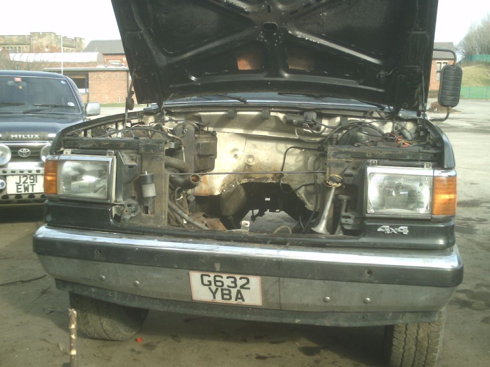 1989 Ford Bronco front view, hood open, engine bay visible, chrome bumper, license plate G632 YBA
