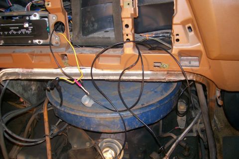 1982 Ford E350 - This image shows the interior of a vehicle's dashboard area with various wires and components visible. A blue circular component, possibly…