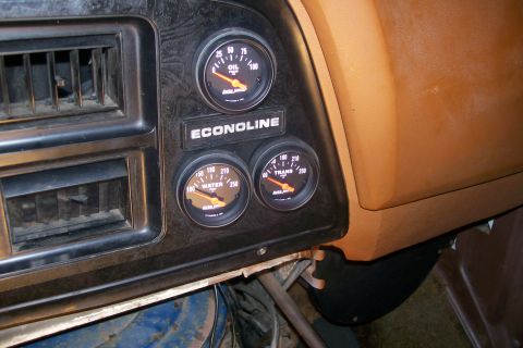 1982 Ford E350 - A close-up view of the dashboard of a Ford Econoline van, showing three gauges: oil pressure, water temperature, and transmission temperatu…