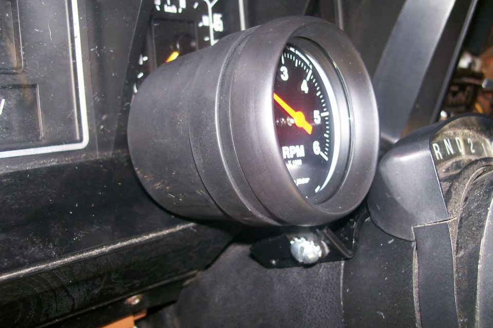 Close-up of a tachometer gauge on a vehicle dashboard.