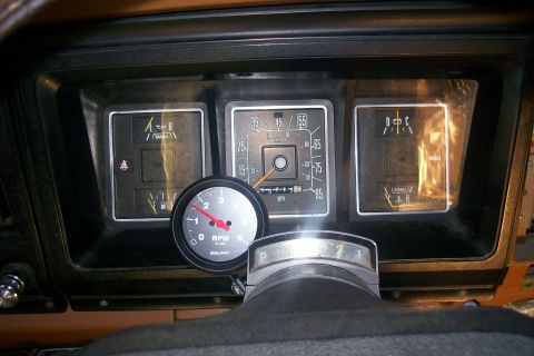 1982 Ford E350 - The interior of a vintage Ford E-Series van shows a close-up of the dashboard gauges, including a speedometer, tachometer, and fuel/tempera…