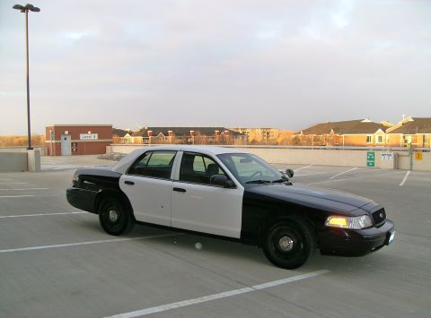 2004 Ford Crown Victoria - This 2004 Ford Crown Victoria police car is parked in a lot with a two-tone paint scheme.