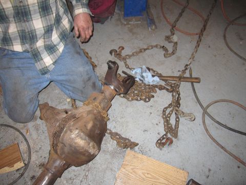 1992 Ford Bronco - Differential assembly and chains on a workshop floor.