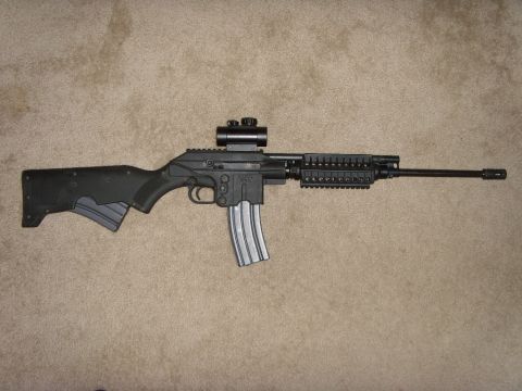 1978 Ford Bronco - A K-22 rifle with a mounted scope and an extended magazine is displayed on a carpeted surface.
