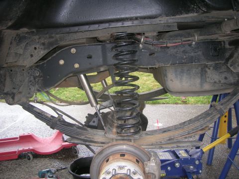 1996 Ford Bronco - The rear suspension of a 1996 Ford Bronco is shown, including leaf springs, a coil spring, and a shock absorber.