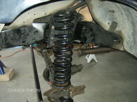 1990 Ford Bronco - The image shows the front suspension and axle of a vehicle, likely undergoing modifications or repairs.
