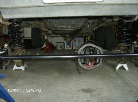 1990 Ford Bronco - Vehicle undercarriage with suspension work in progress, showing front axle and springs. Dated 03/01/2009.