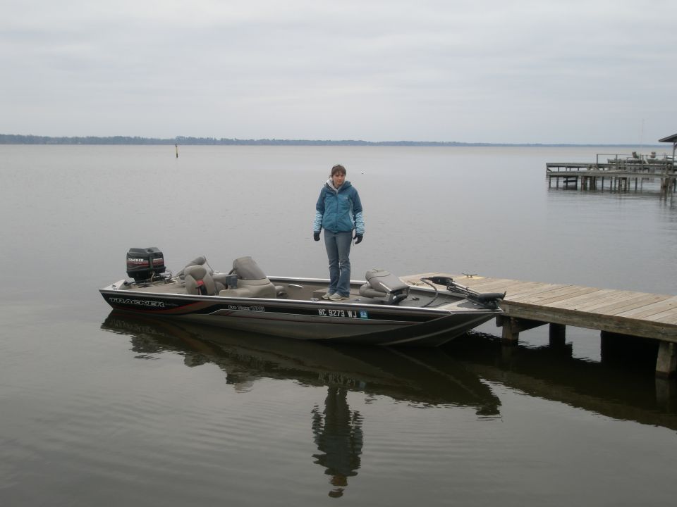 Boat docked at a pier with a person standing on it