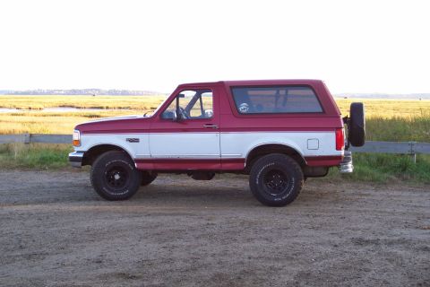 1995 Ford Bronco - This two-tone Ford Bronco is shown from the side with a spare tire mounted on the back.