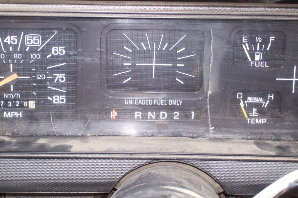 1986 Ford F-150 dashboard with speedometer, fuel gauge, and temperature gauge