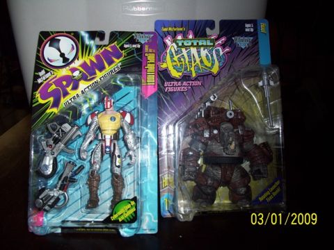 1991 Ford Bronco - Two collectible action figures, Spawn and Total Chaos, are displayed in their original packaging.