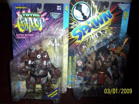 1991 Ford Bronco - Two collectible action figures, one from Total Chaos and one from Spawn, are displayed in their packaging.