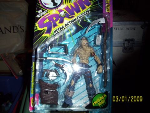 1991 Ford Bronco - A Spawn action figure is displayed in its original packaging with accessories.