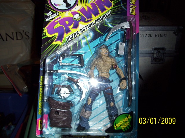 Spawn action figure in packaging, with accessories like a scythe and a bag