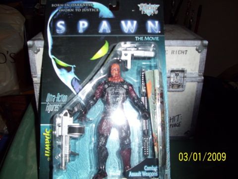 1991 Ford Bronco - A Spawn action figure is displayed in its original packaging with various accessories.