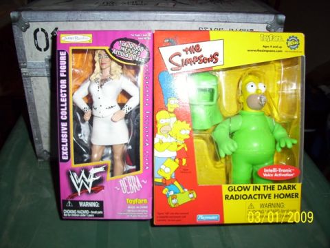 1991 Ford Bronco - Two collectible toy figures are displayed in their original packaging.