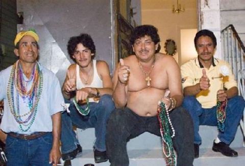 1973 Ford Torino - Four men pose on steps, adorned with colorful Mardi Gras beads, with two giving thumbs up.