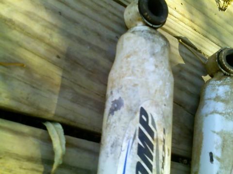 1996 Ford Bronco - Pair of shock absorbers with visible branding, likely for automotive use.