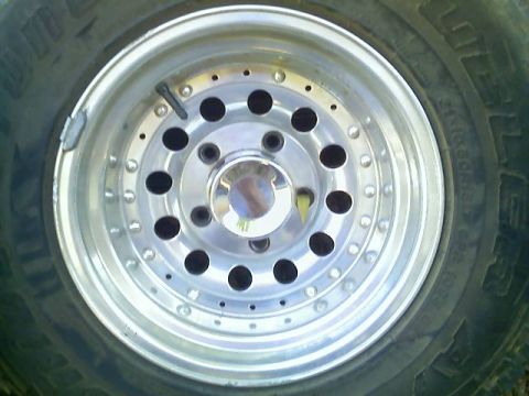 1996 Ford Bronco - Close-up of a vehicle's wheel and tire, showing the tread pattern and alloy rim.
