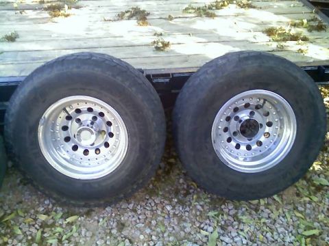 1996 Ford Bronco - A pair of aftermarket aluminum rims with tires are shown, likely for sale.